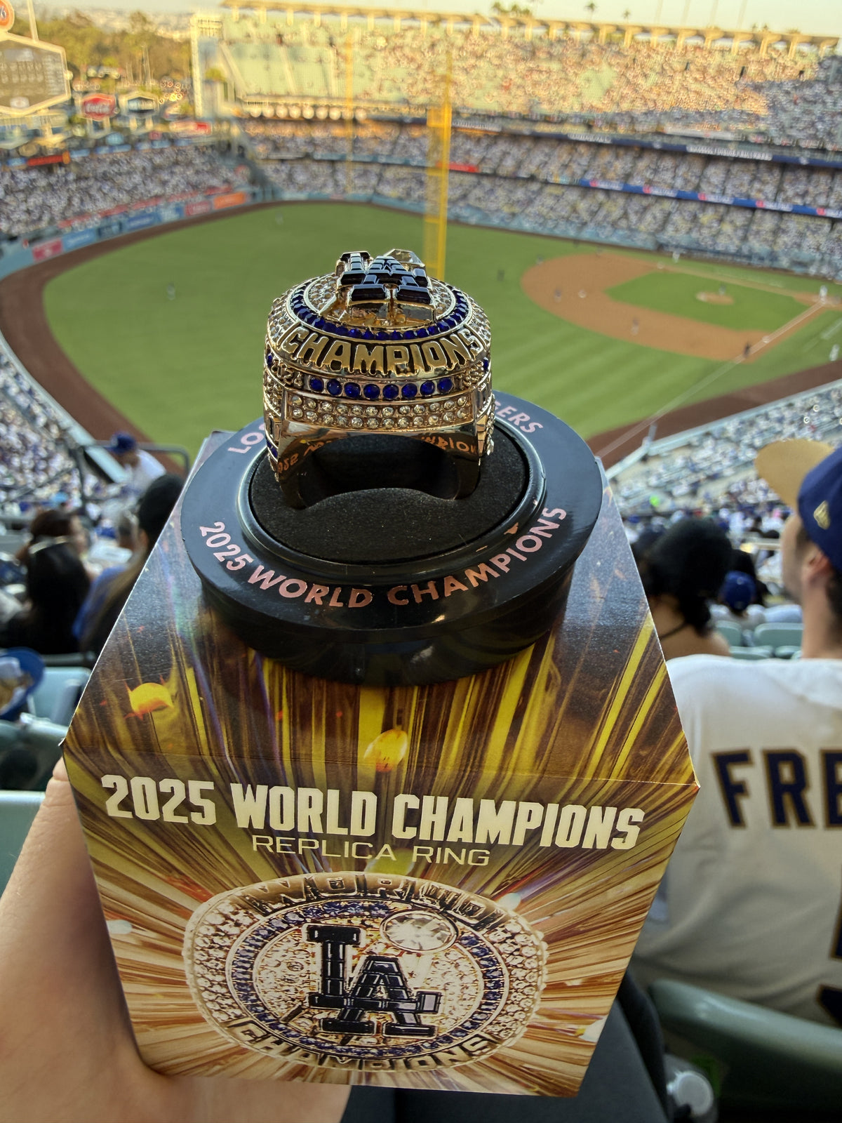Los Angeles Dodgers 2025 World Champions replica ring on its display stand with the retail box, at Dodger Stadium