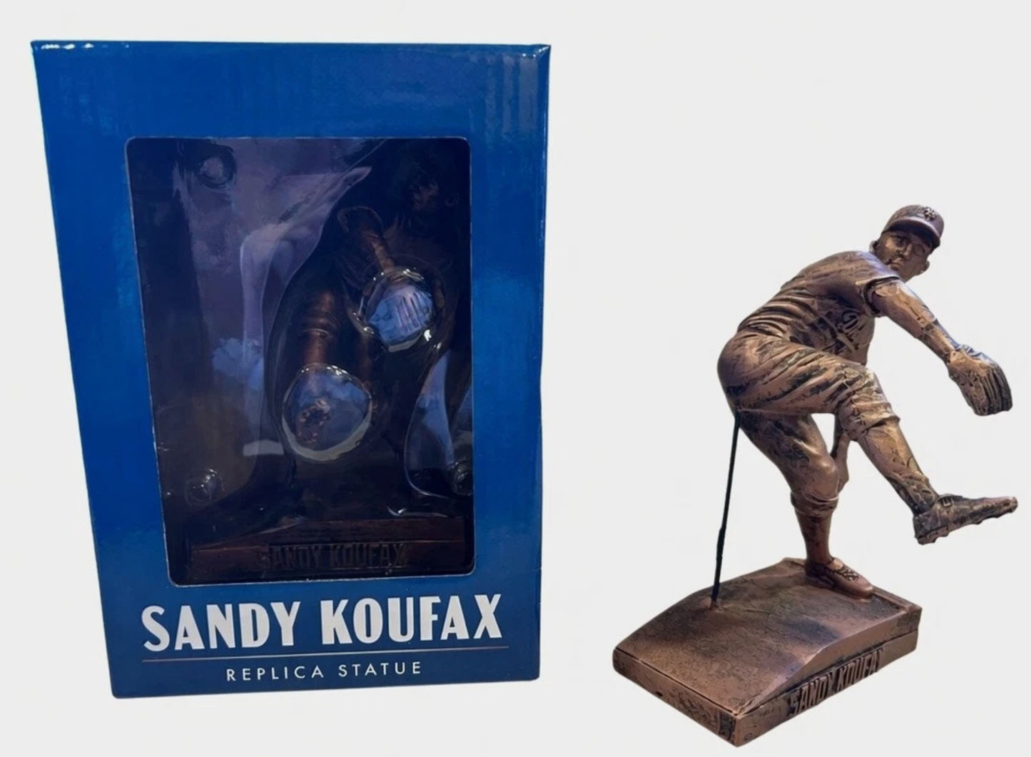 Sandy Koufax replica statue shown boxed and out of box — bronze-finish pitching pose on nameplate base